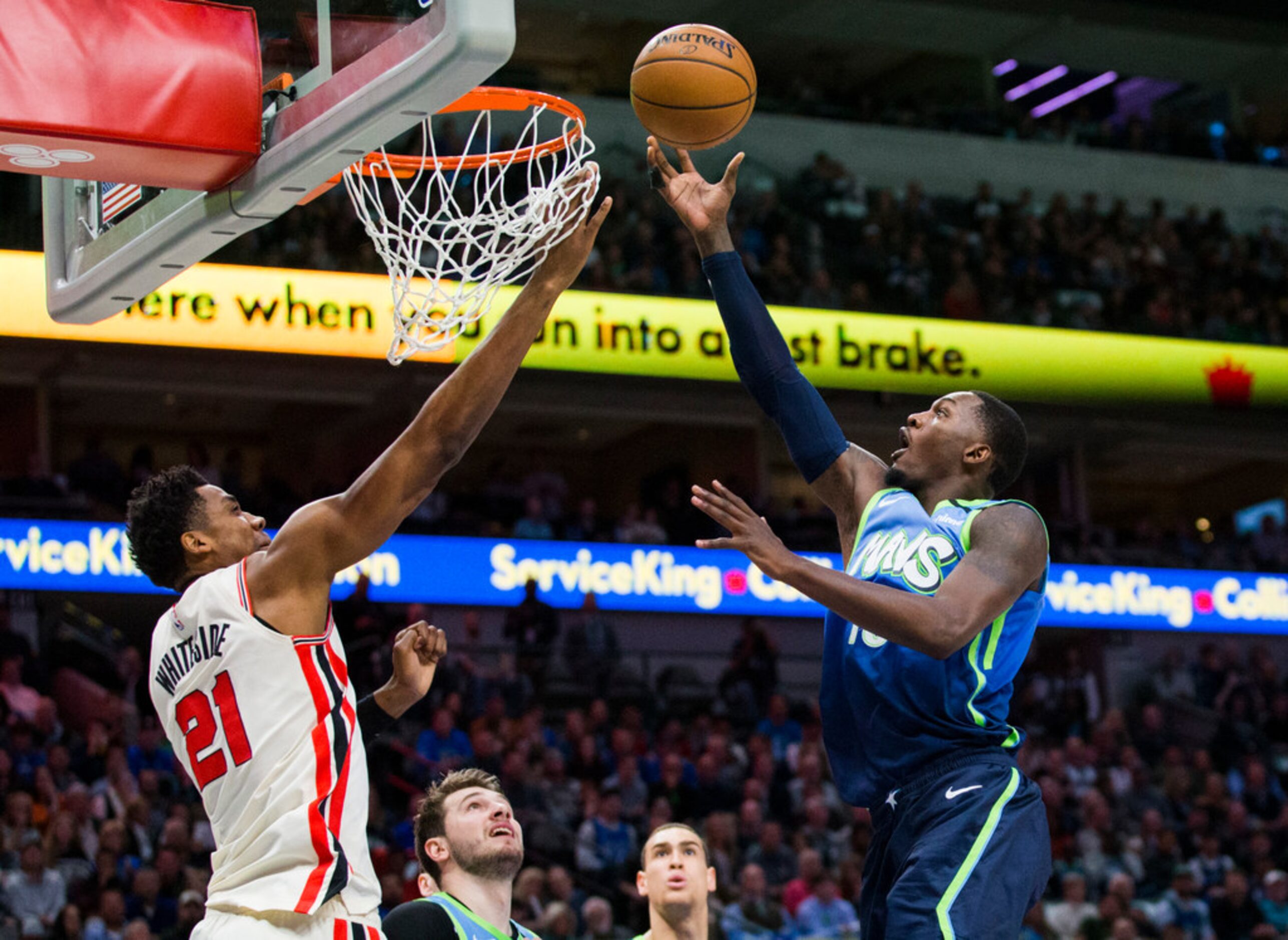 Dallas Mavericks forward Dorian Finney-Smith (10) goes up for a shot against Portland Trail...