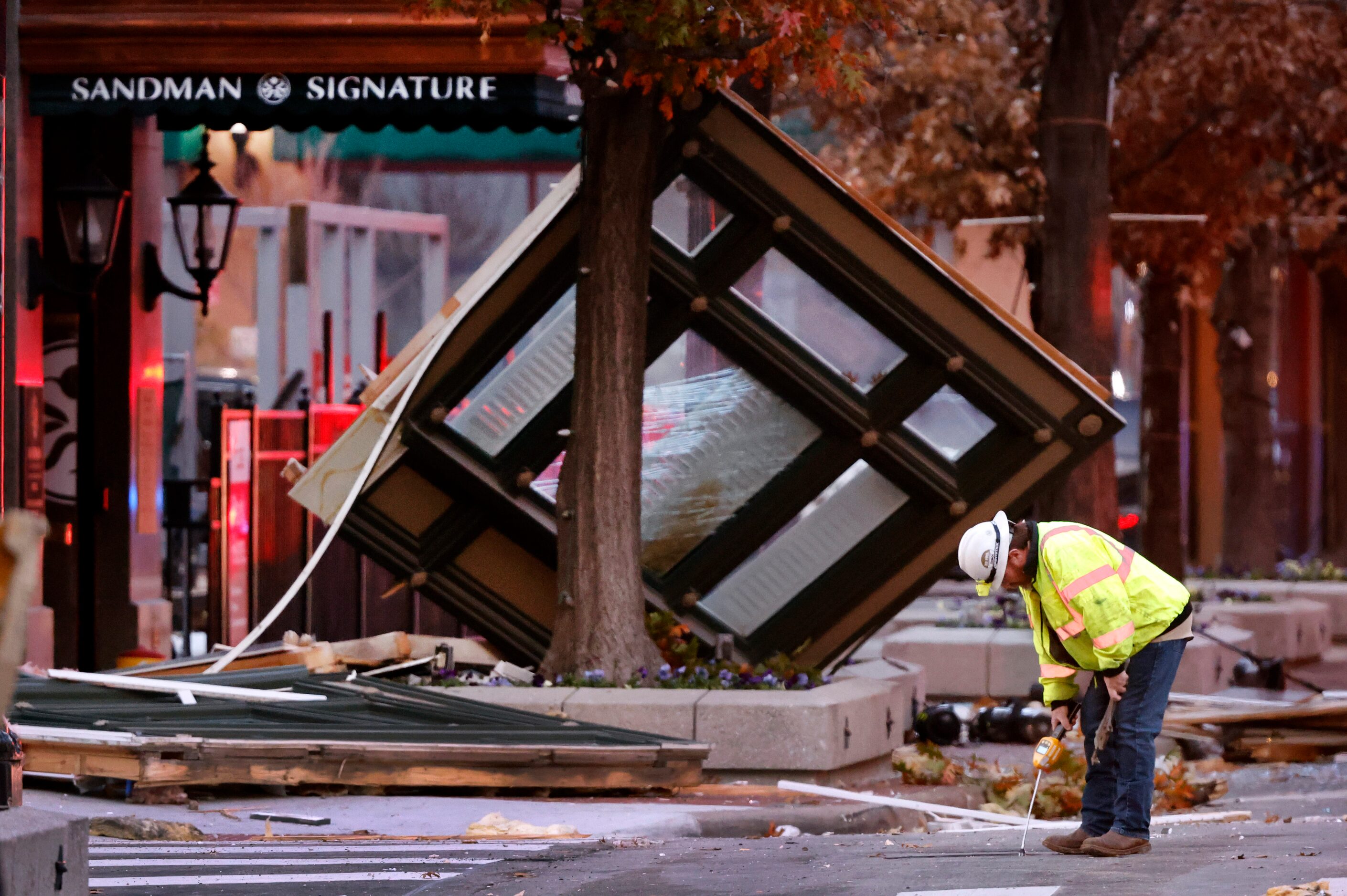 An Atmos Energy official takes readings on Houston St, the site where an explosion occurred...