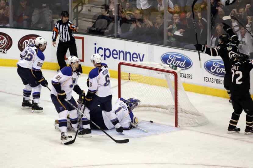 Dallas' players react after their first goal to tie the game was scored by Erik Cole during...