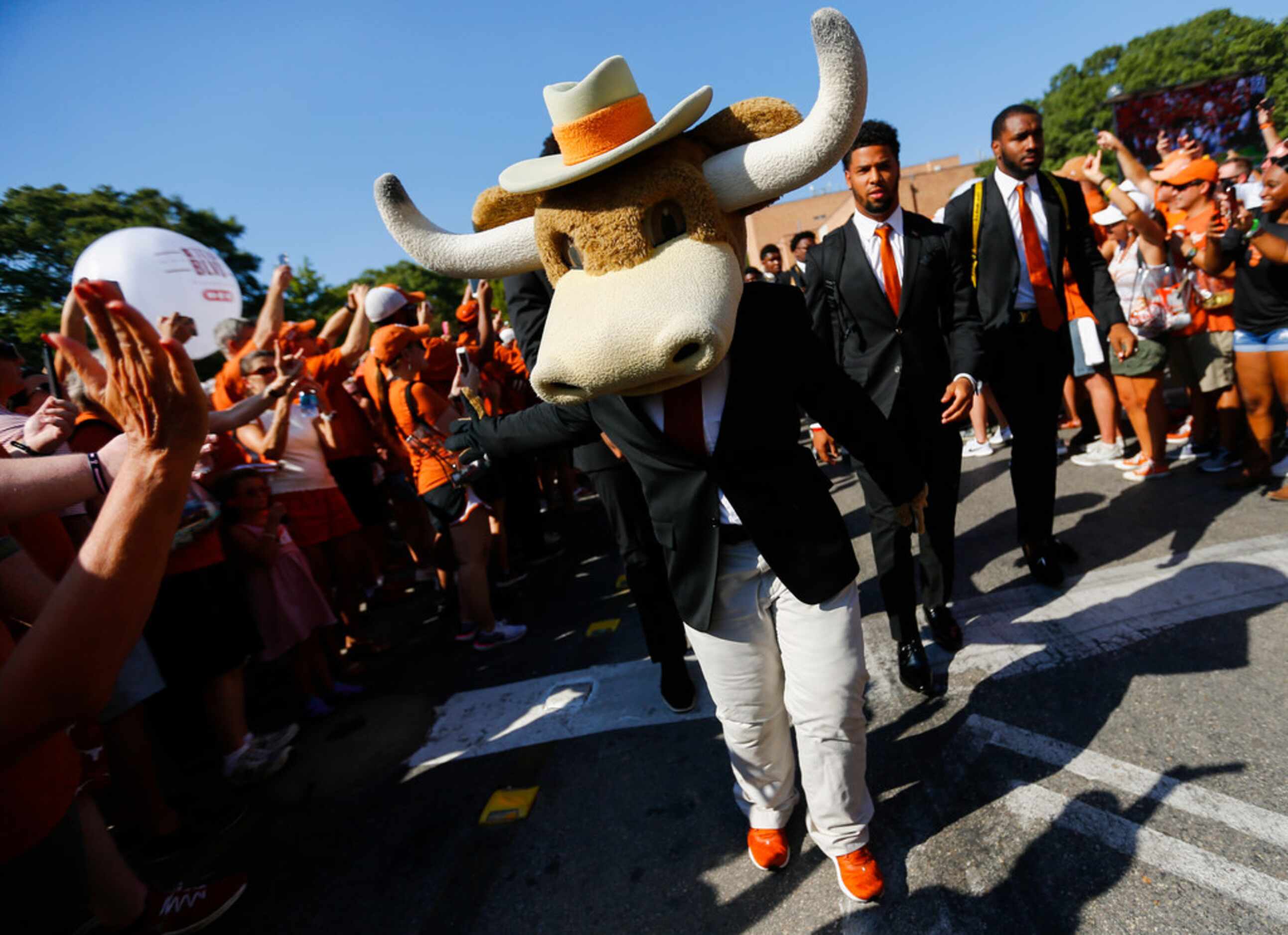 The Texas Longhorns greet fans as they make their way down Bevo Boulevard prior to a college...