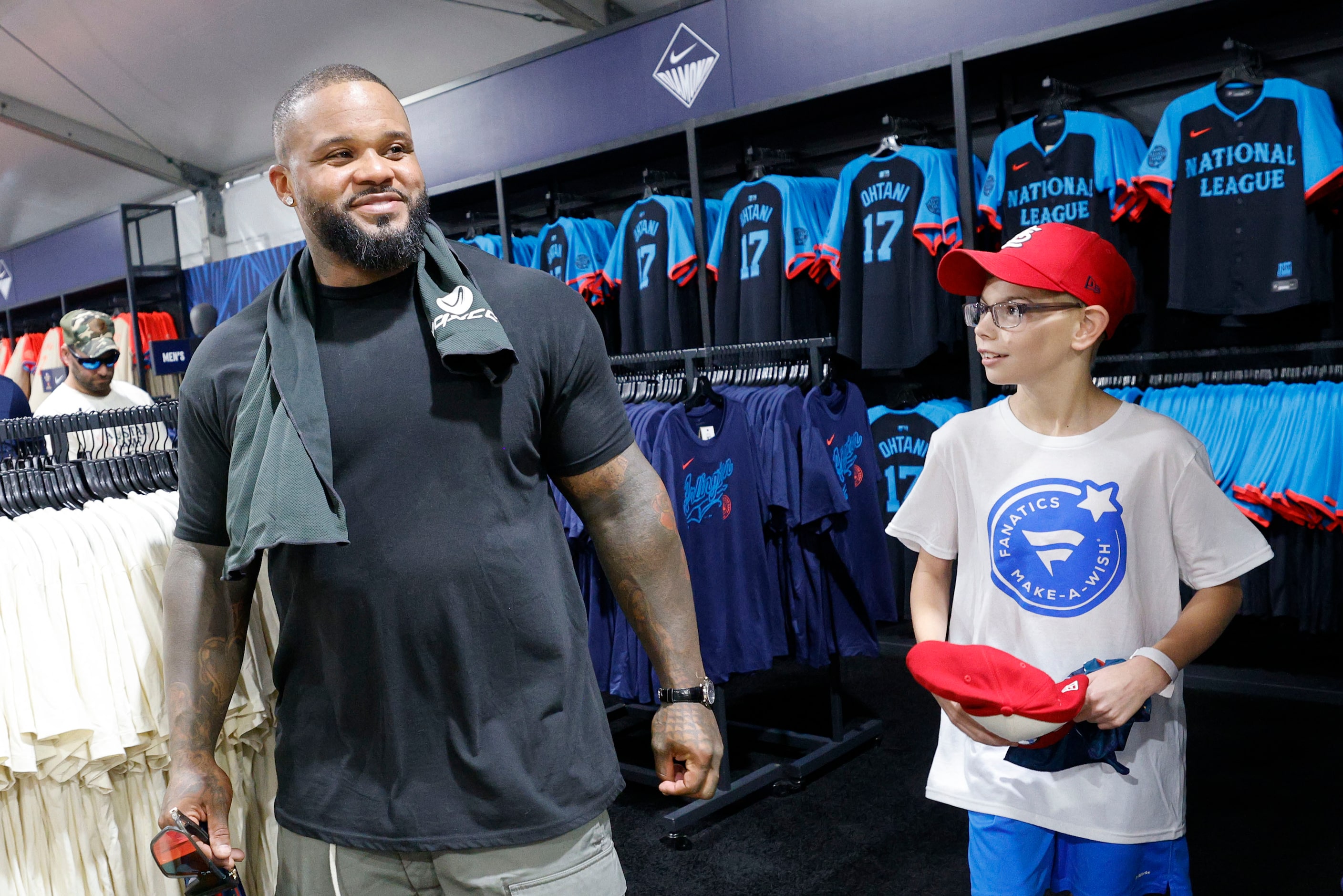 Make-a-Wish kid Steven Long, 11, of Troy Ill. walks with former Texas Rangers slugger Prince...