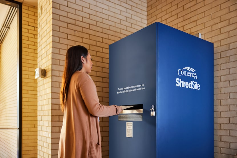 Woman uses blue Comerica ShredSite bin