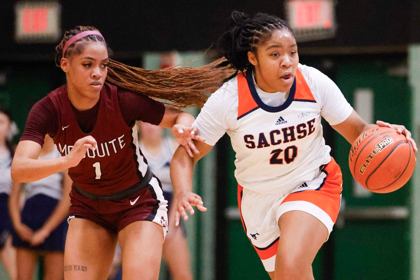 Mesquite’s Kayla Smolley (left) runs along Sachse’s Reese Hodge during the first half of a...