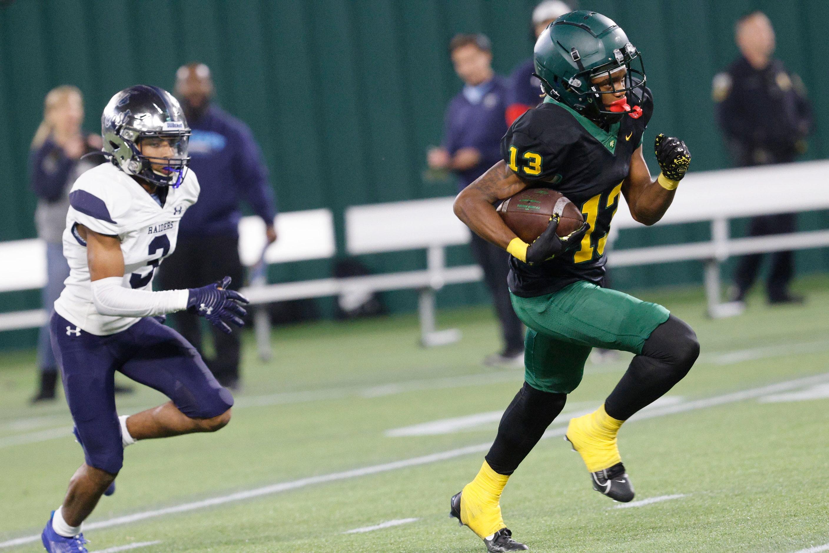 DeSoto's Daylon Singleton (13) carries the ball as Wylie East's Jamal Olford (3) follows...