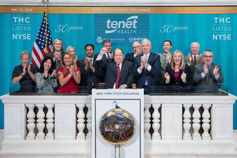 Tenet's Ronald Rittenmeyer (center) rang the opening bell at the New York Stock Exchange on...