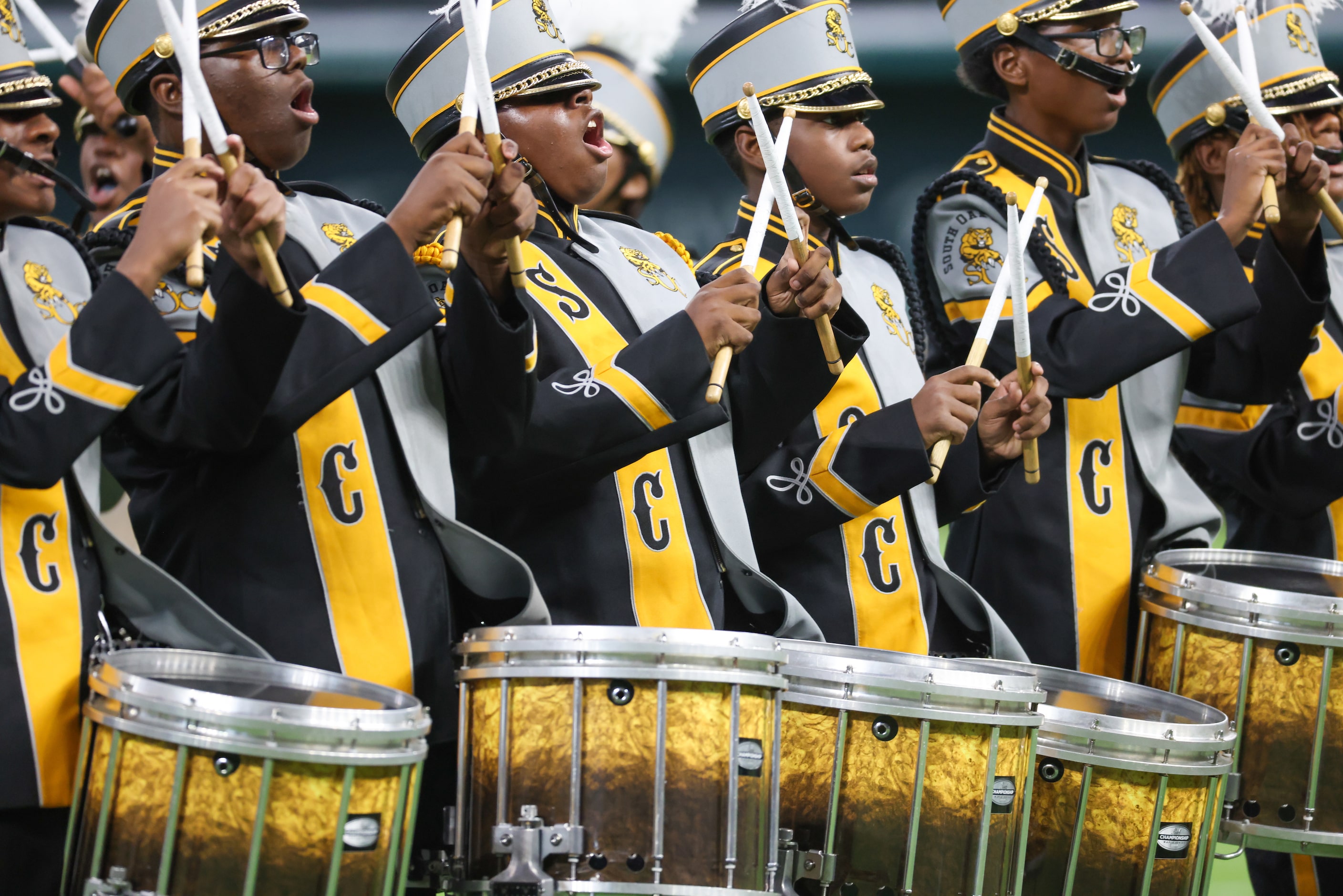 The South Oak Cliff High School marching band drumline yell during their performance at the...