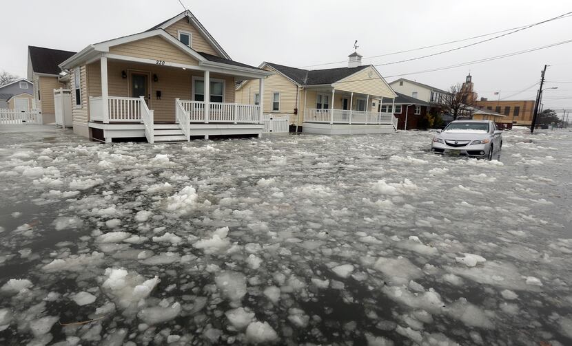  Water and ice floods 12th Ave in North Wildwood, N.J., at the height the storm on Saturday,...