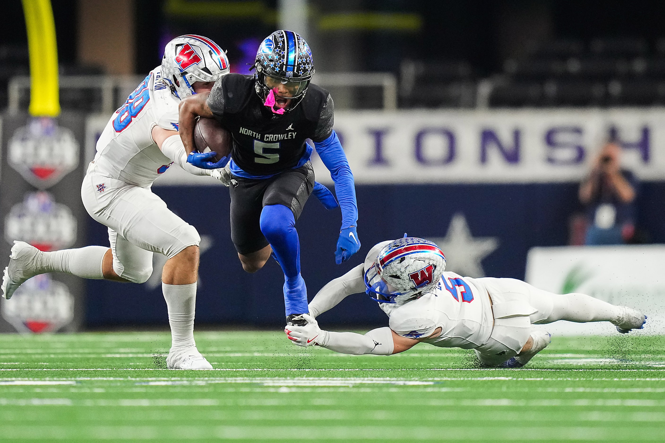 North Crowley running back Daniel Bray is tripped up by Austin Westlake linebacker Payton...