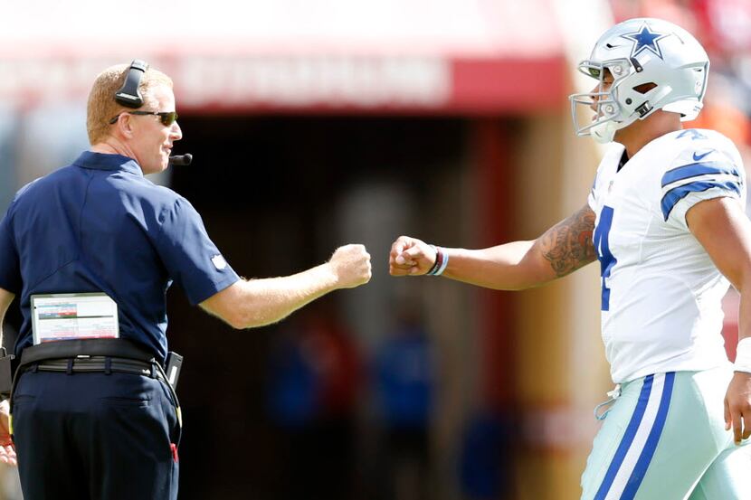 Dallas Cowboys head coach Jason Garrett and Dallas Cowboys quarterback Dak Prescott (4)...
