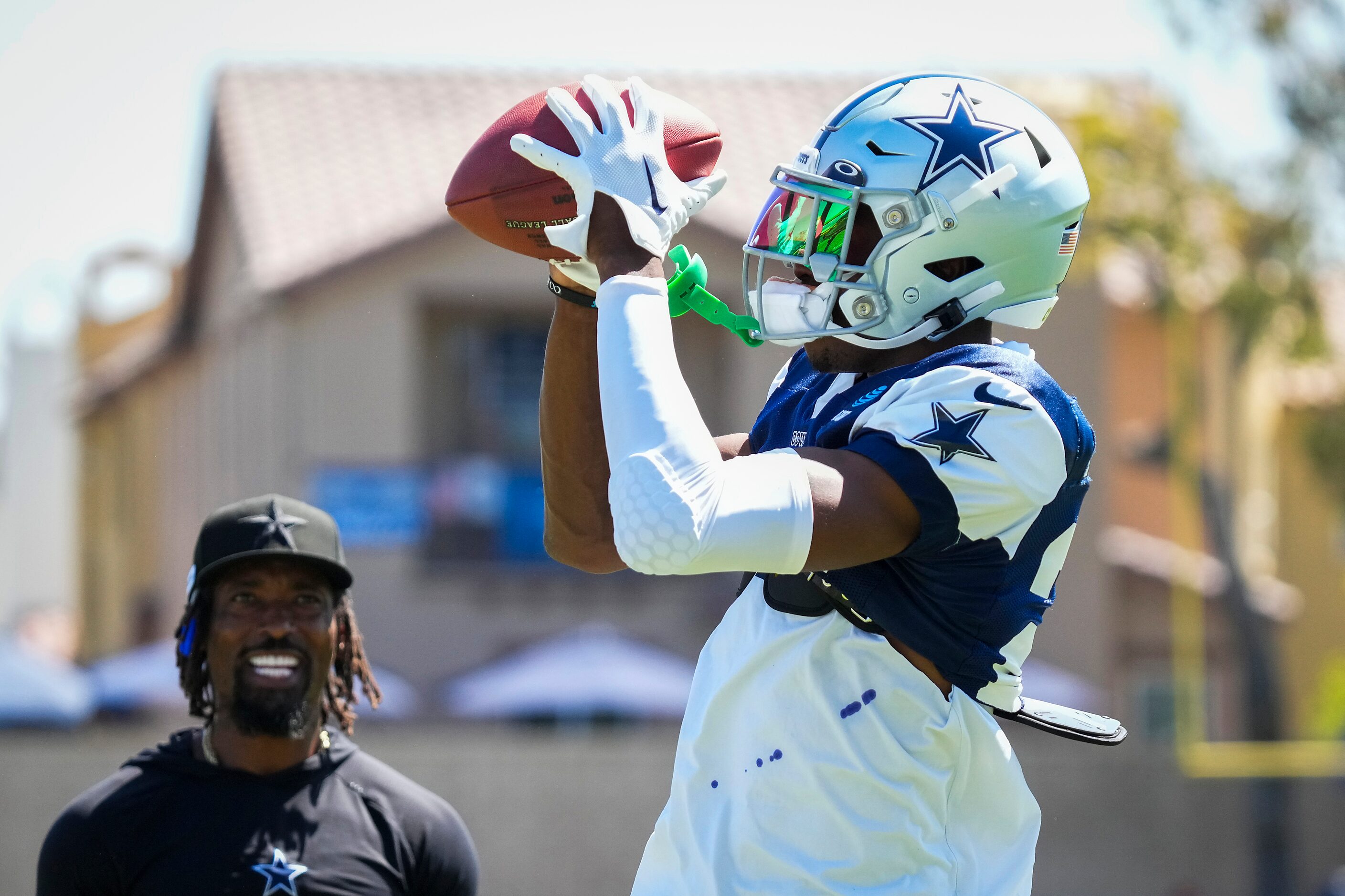 Dallas Cowboys safety Israel Mukuamu (24) catches a ball as defensive backs coach Al Harris...