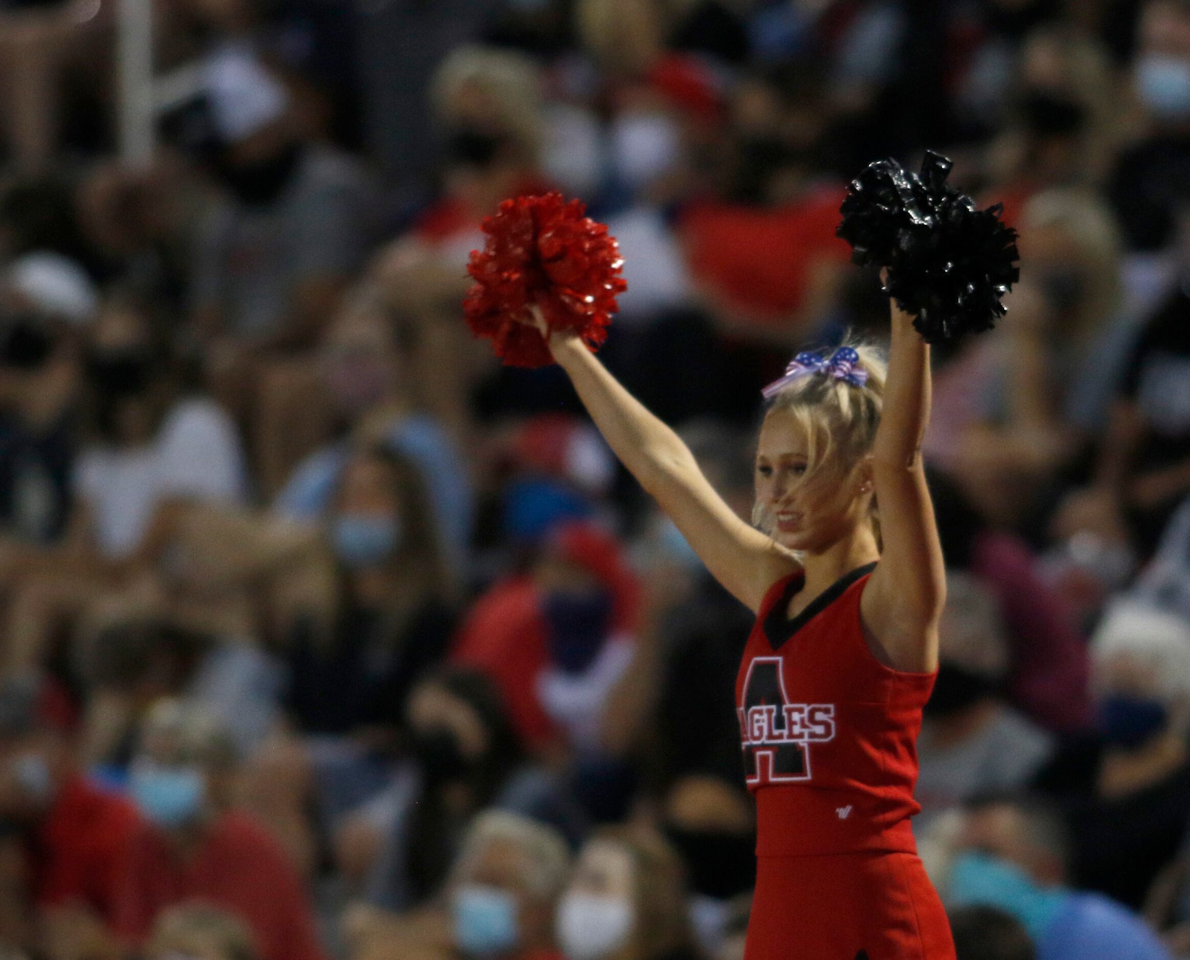 An Argyle cheerleader watches, as do Eagles fans, the opening kickoff of the Argyle versus...