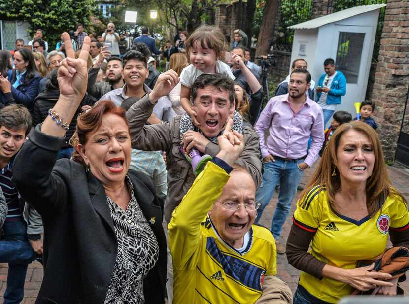 People celebrate the results of a referendum on whether to ratify a historic peace accord to...