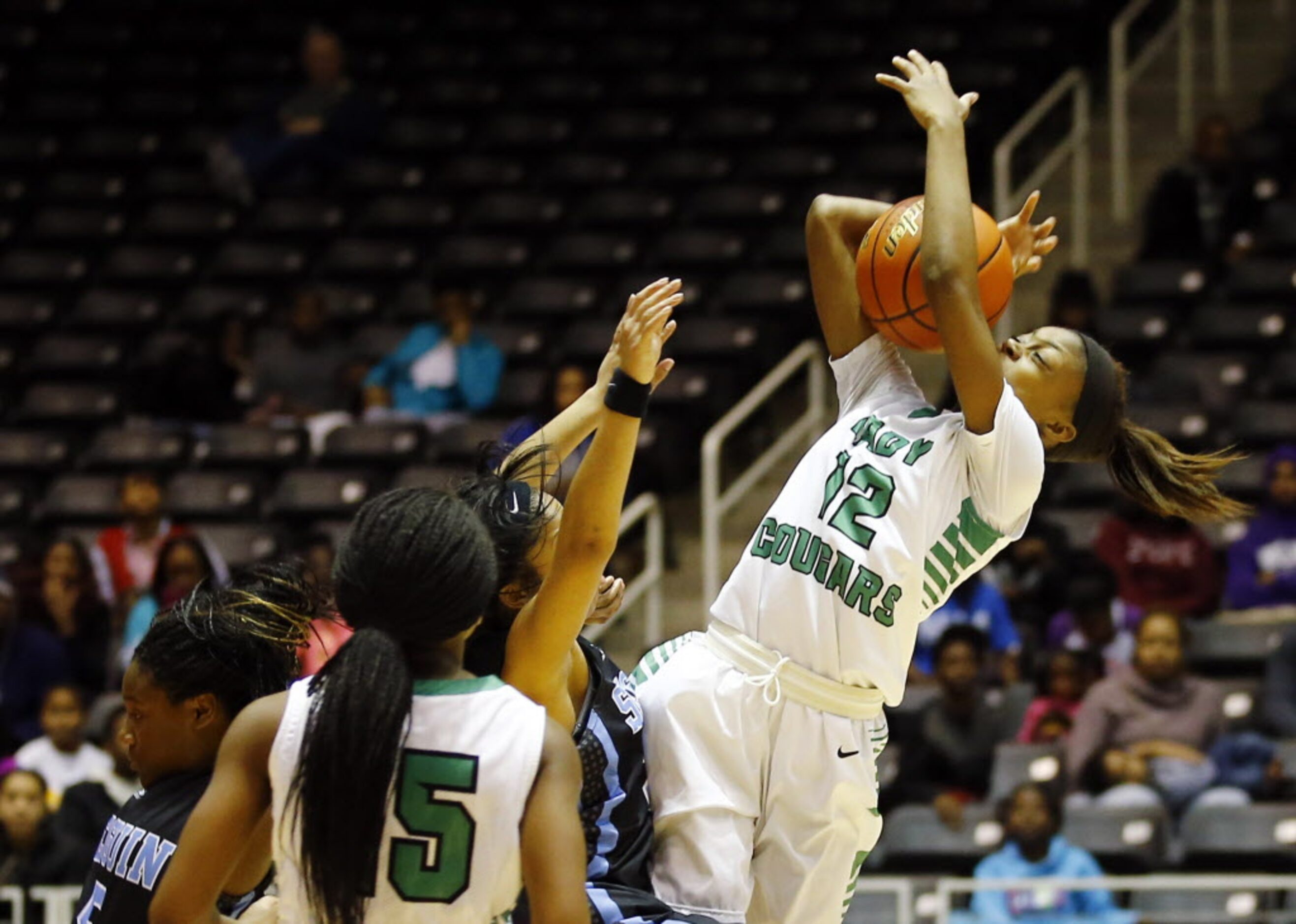 Bryan Adams' Alexxus Gilbert (12) tries to get off a shot under pressure during the Class 5A...