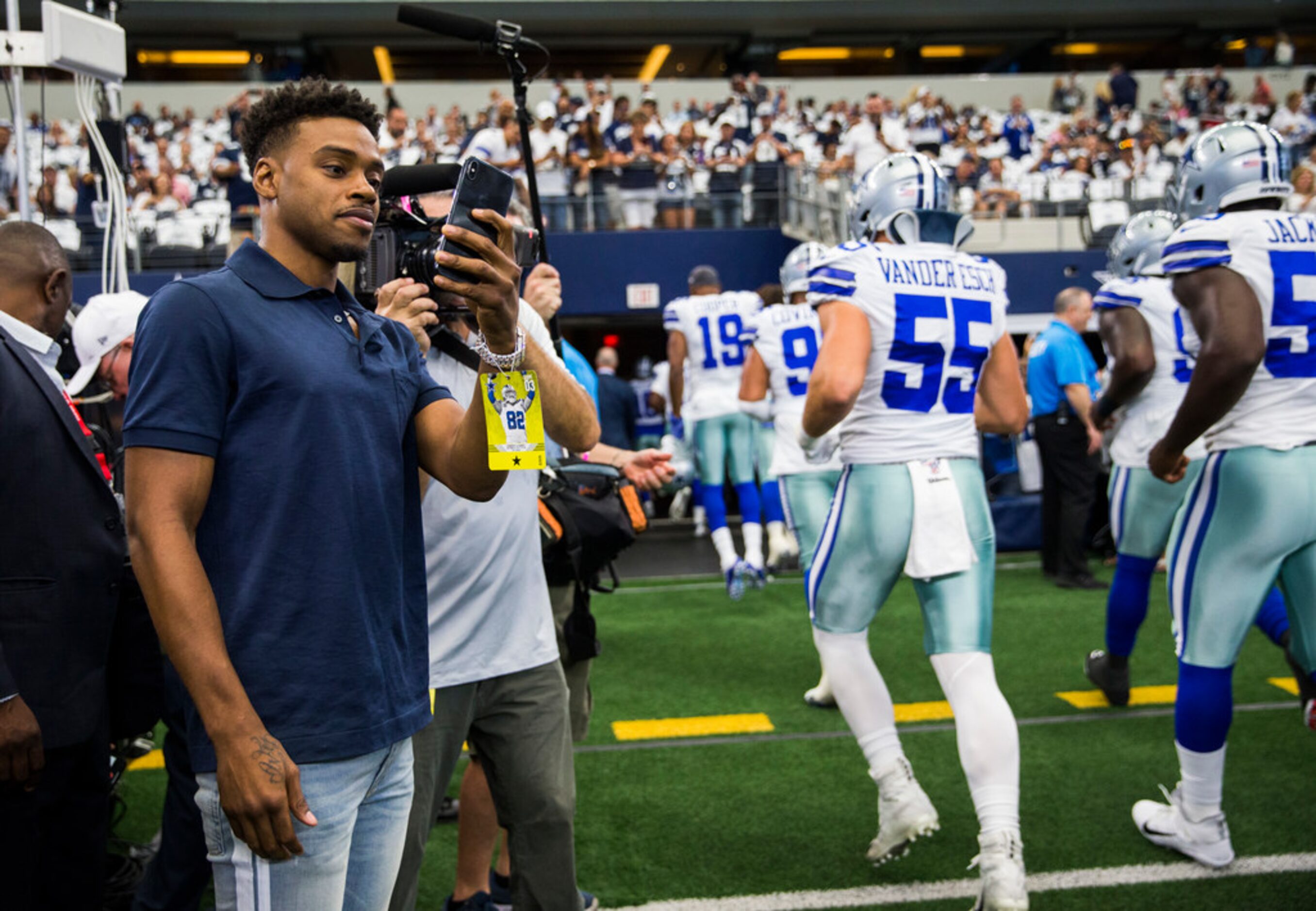 Boxer Errol Spence Jr. watches as the Cowboys leave the field after warmups before an NFL...