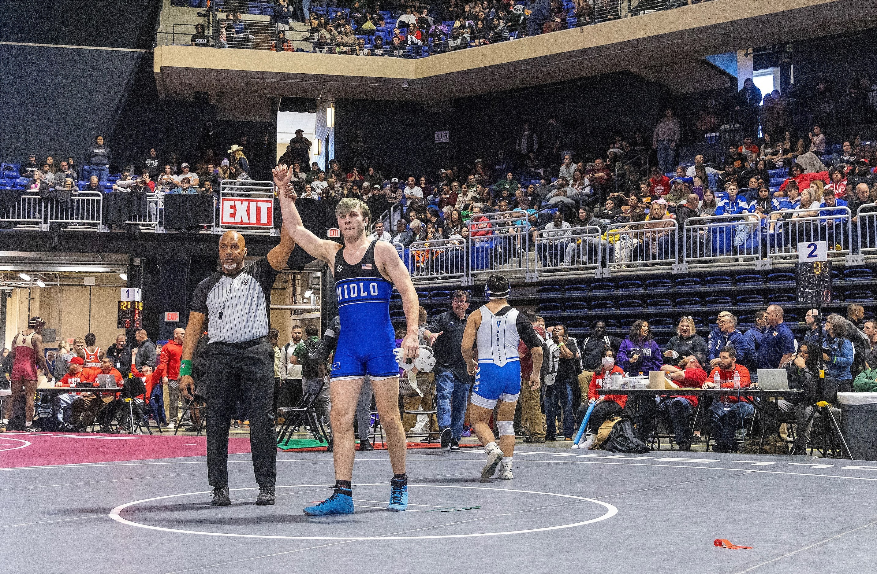 Karson Tompkins with the red ankle marker wrestles Joaquin Cordero with the green ankle...