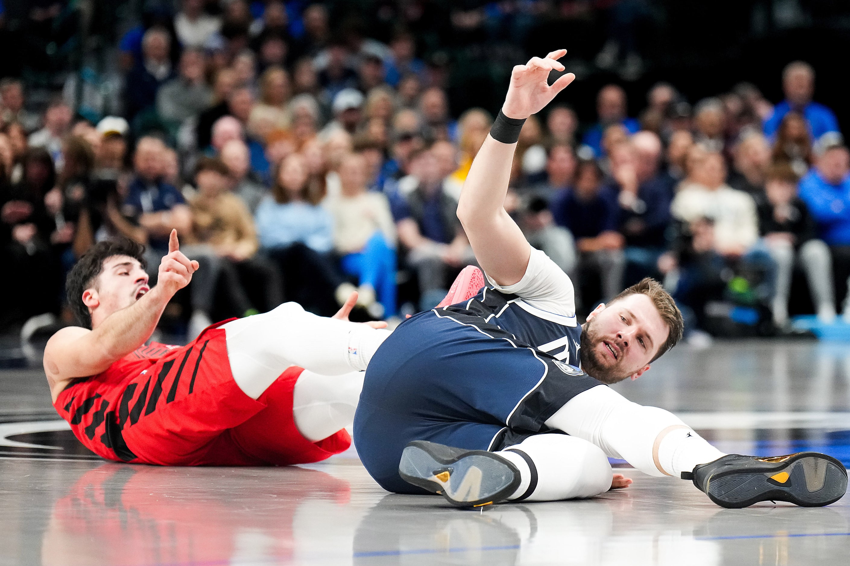 Dallas Mavericks guard Luka Doncic (77) hits the floor after being fouled by Portland Trail...