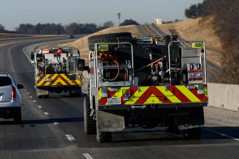 Grand Prairie firetrucks roll down Interstate 20 on Saturday in West Texas, where wildfires...