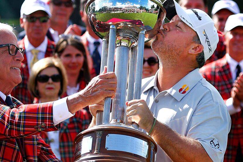 PGA Tour golfer Boo Weekley kisses the Marvin Leonard Trophy after winning the Crowne Plaza...