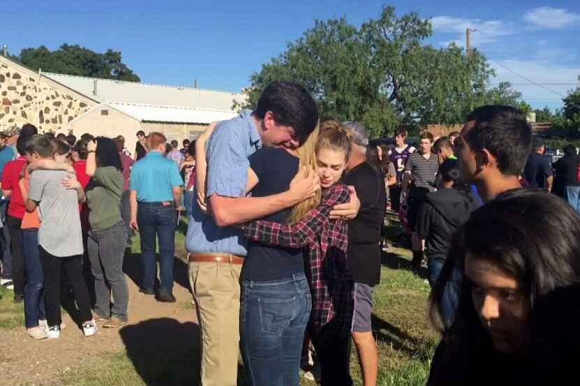 People gathered near the Alpine High School campus Thursday after a shooting at the school.