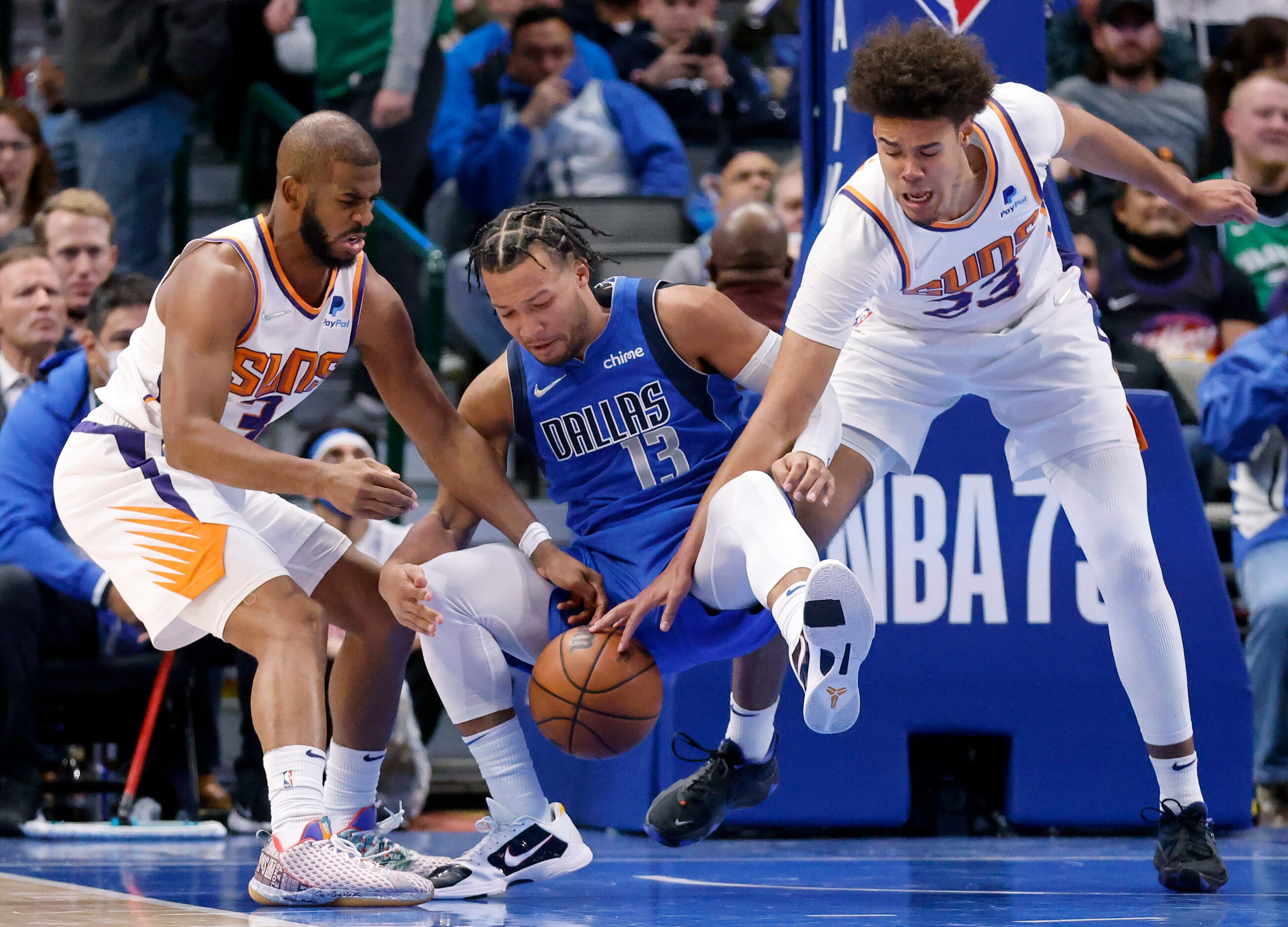 Dallas Mavericks guard Jalen Brunson (13) falls backward into Phoenix Suns forward Cameron...