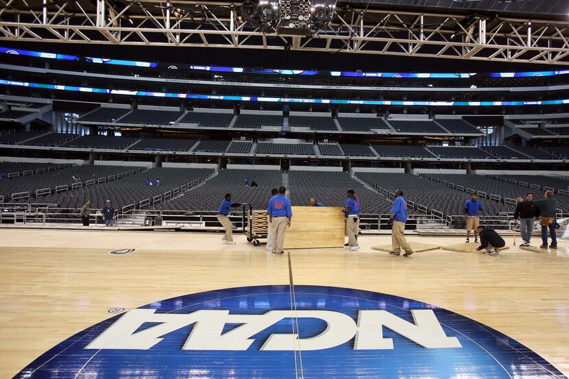 Crews work to set up the floor on Monday, March 25, 2013, for the 2013 NCAA basketball South...