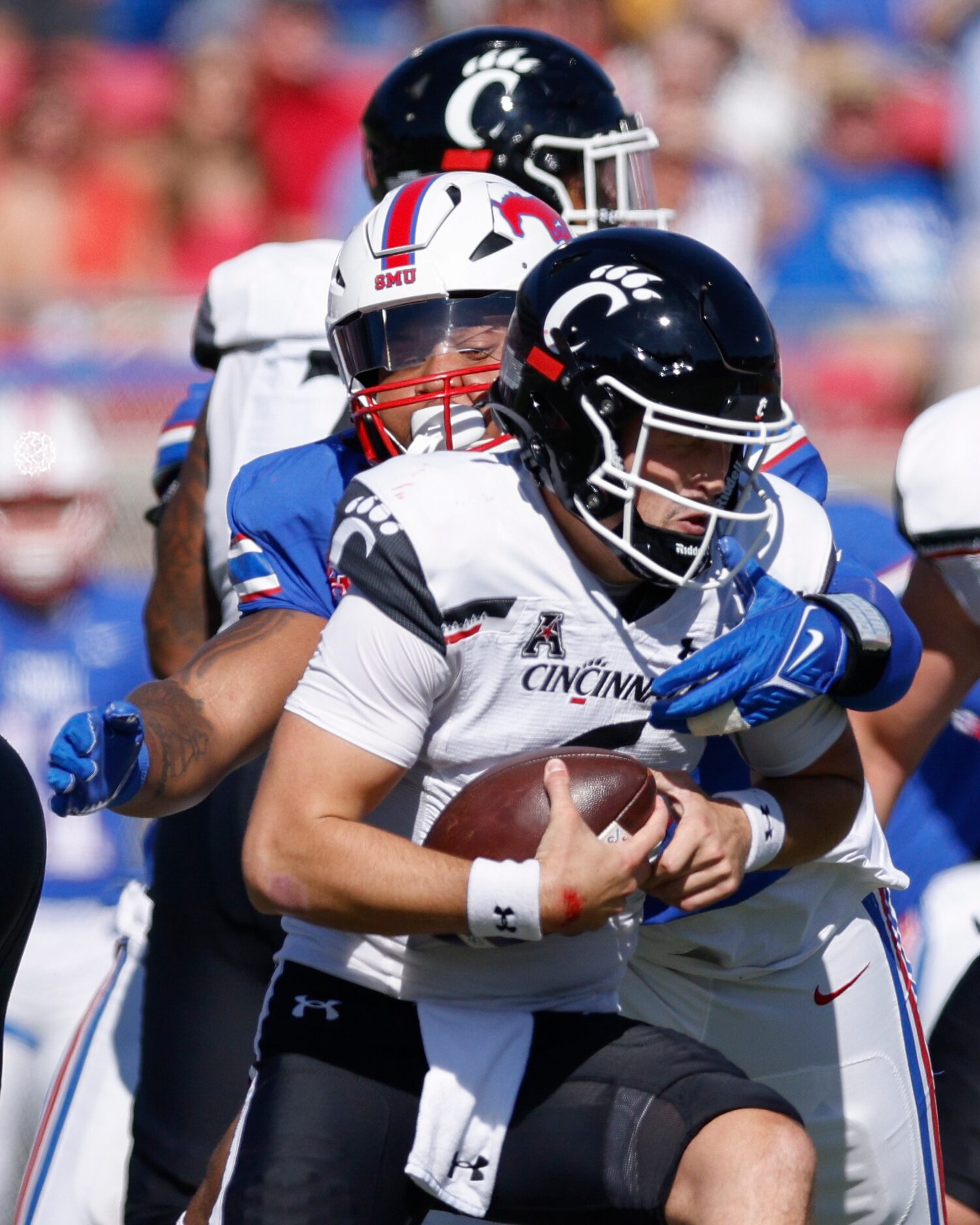 SMU defensive tackle DeVere Levelston (96) sacks Cincinnati quarterback Ben Bryant (6)...