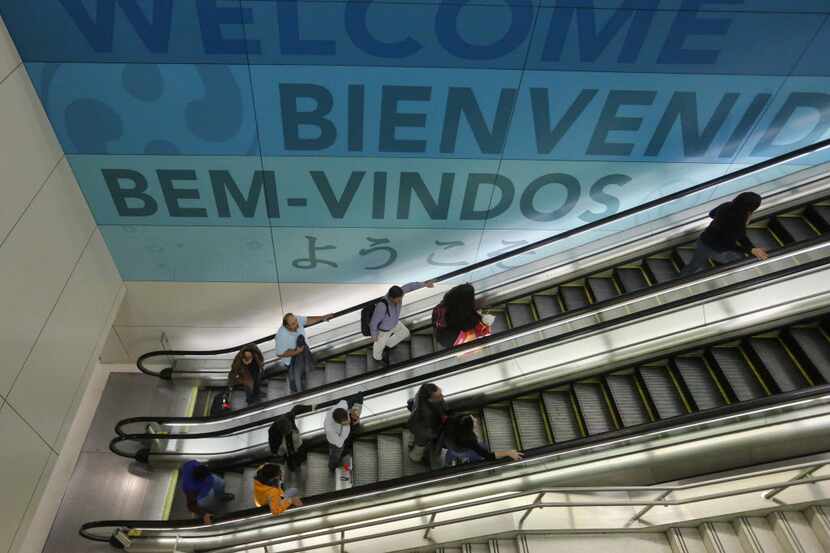  Travelers receive a international greeting at they enter the Dallas/Fort Worth...