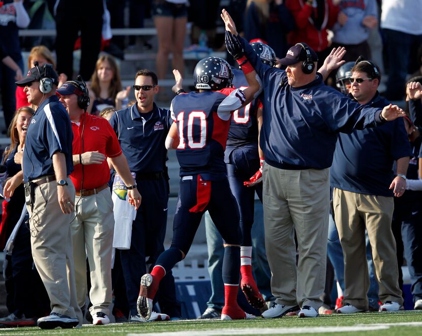 Allen's Troy Knudsen (10) celebrates on the sideline after scoring the first touchdown of...