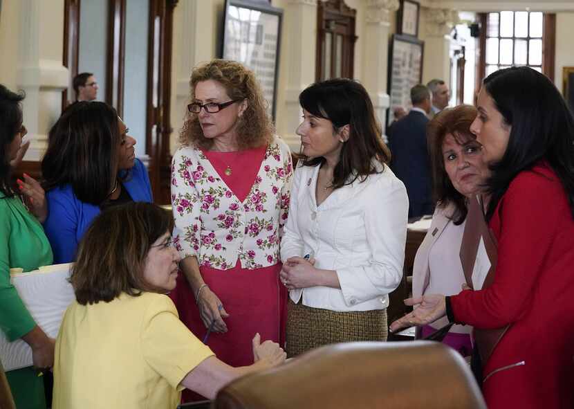 From second from left, state Reps. Nicole Collier, Donna Howard and Gina Hinojosa,  and...