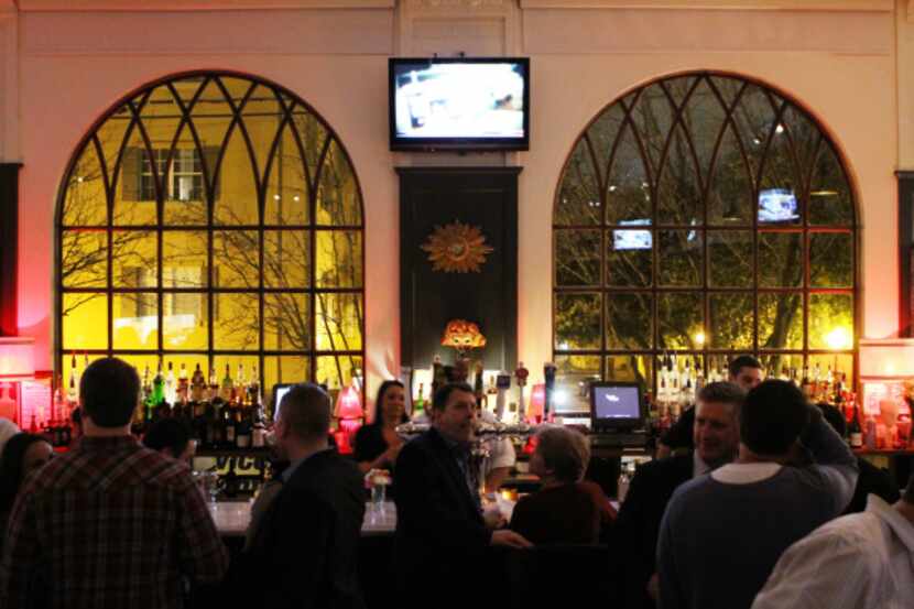 Diners sip drinks and munch on appetizers at the bar during an "opening party" for The Mason...