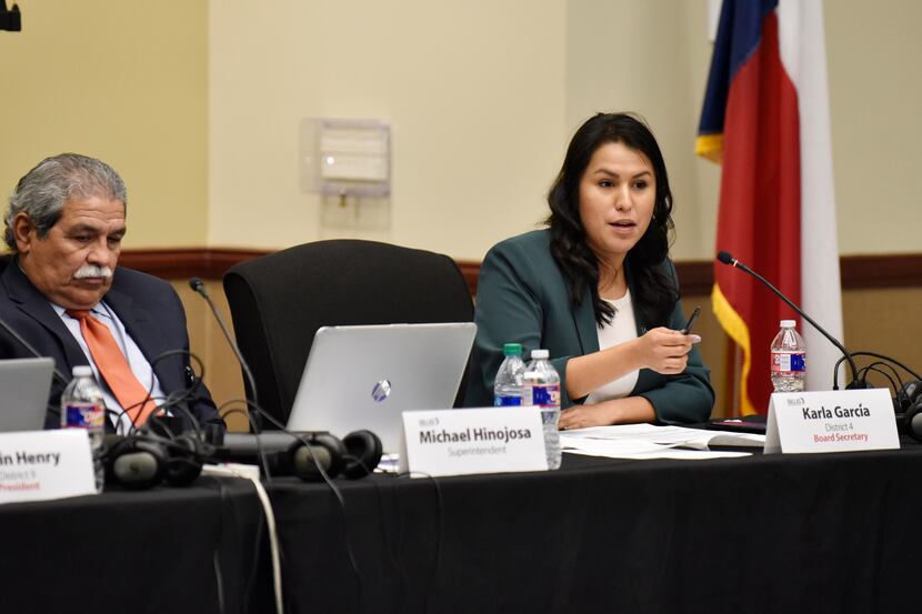 DISD District 4 trustee Karla Garcia, with Superintendent Michael Hinojosa, speaks during a...