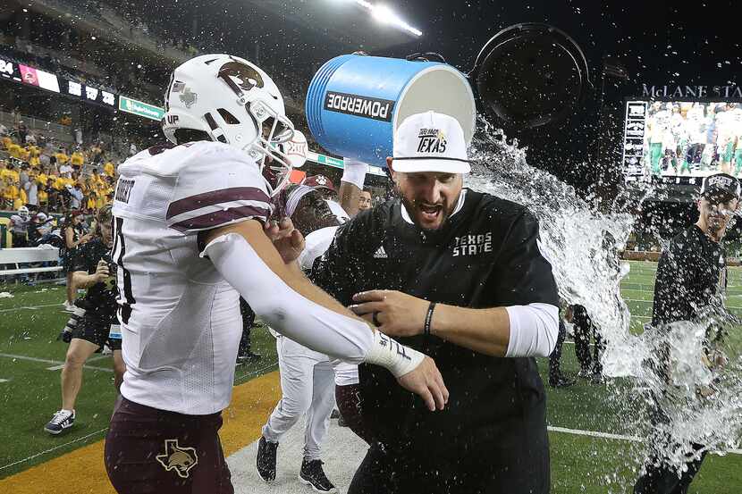 Texas State head coach G.J. Kinne, front right, is doused after his team's victory over...
