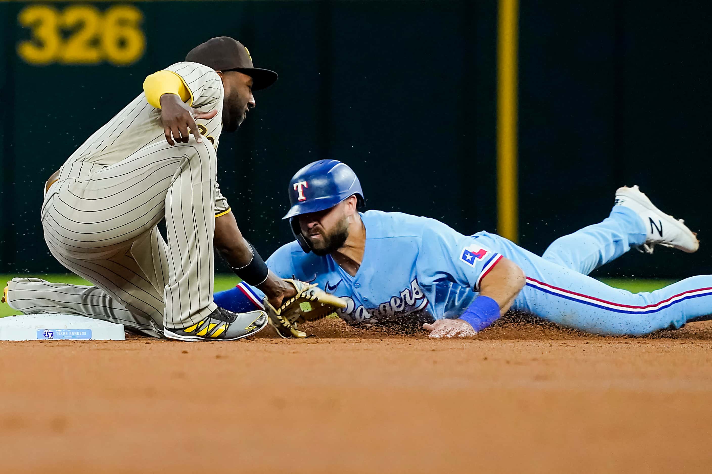 Texas Rangers right fielder Joey Gallo is safe with a stolen base ahead of the throw to San...