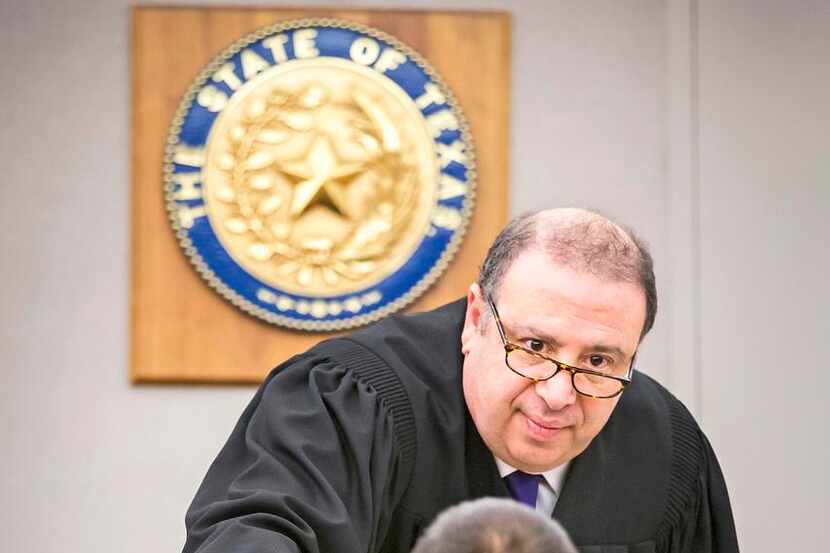 
State District Judge Rick Magnis congratulates a graduate of his Felony Domestic Violence...