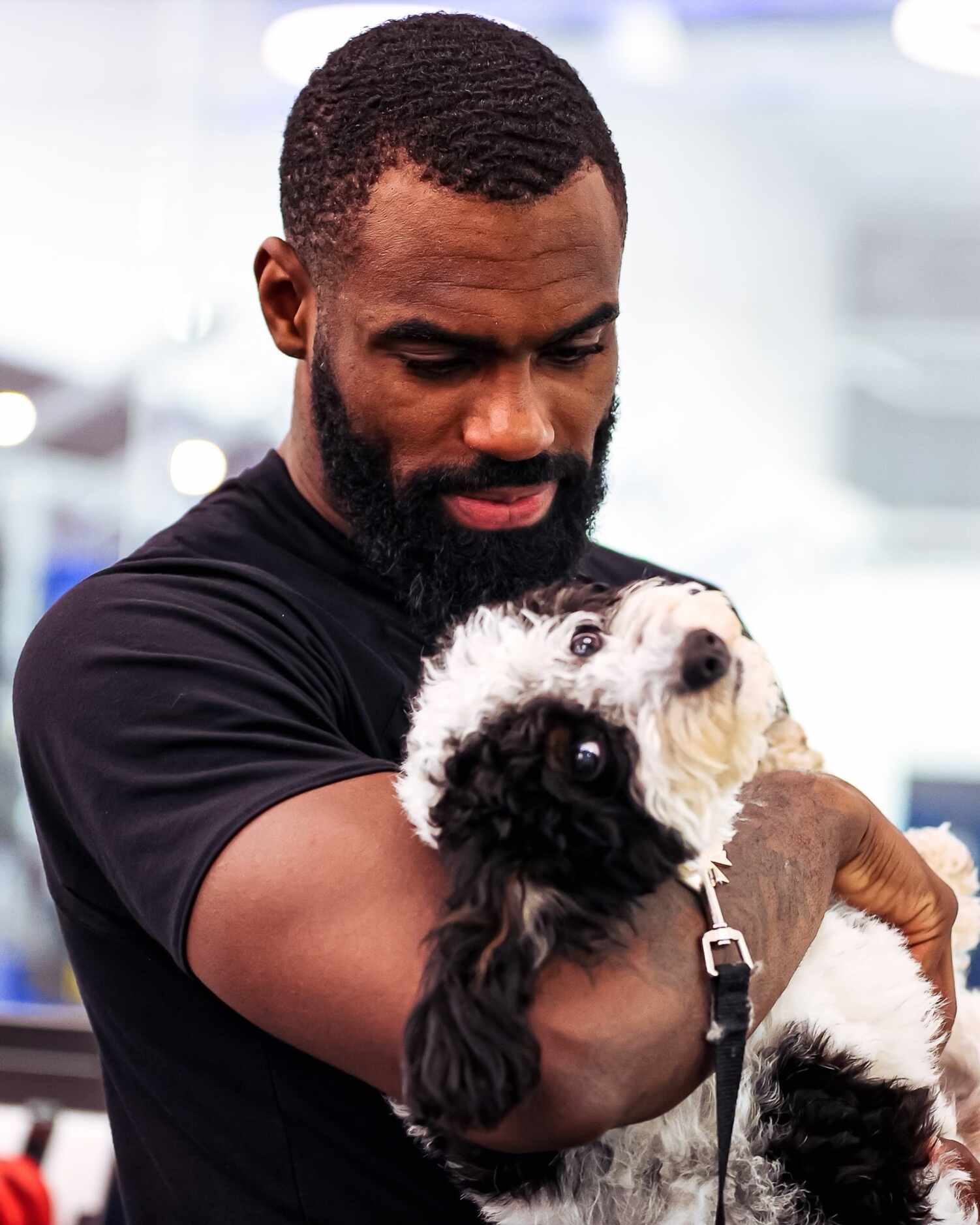 Mavericks guard-forward Tim Hardaway Jr. holds the team's emotional support dog, Bailey