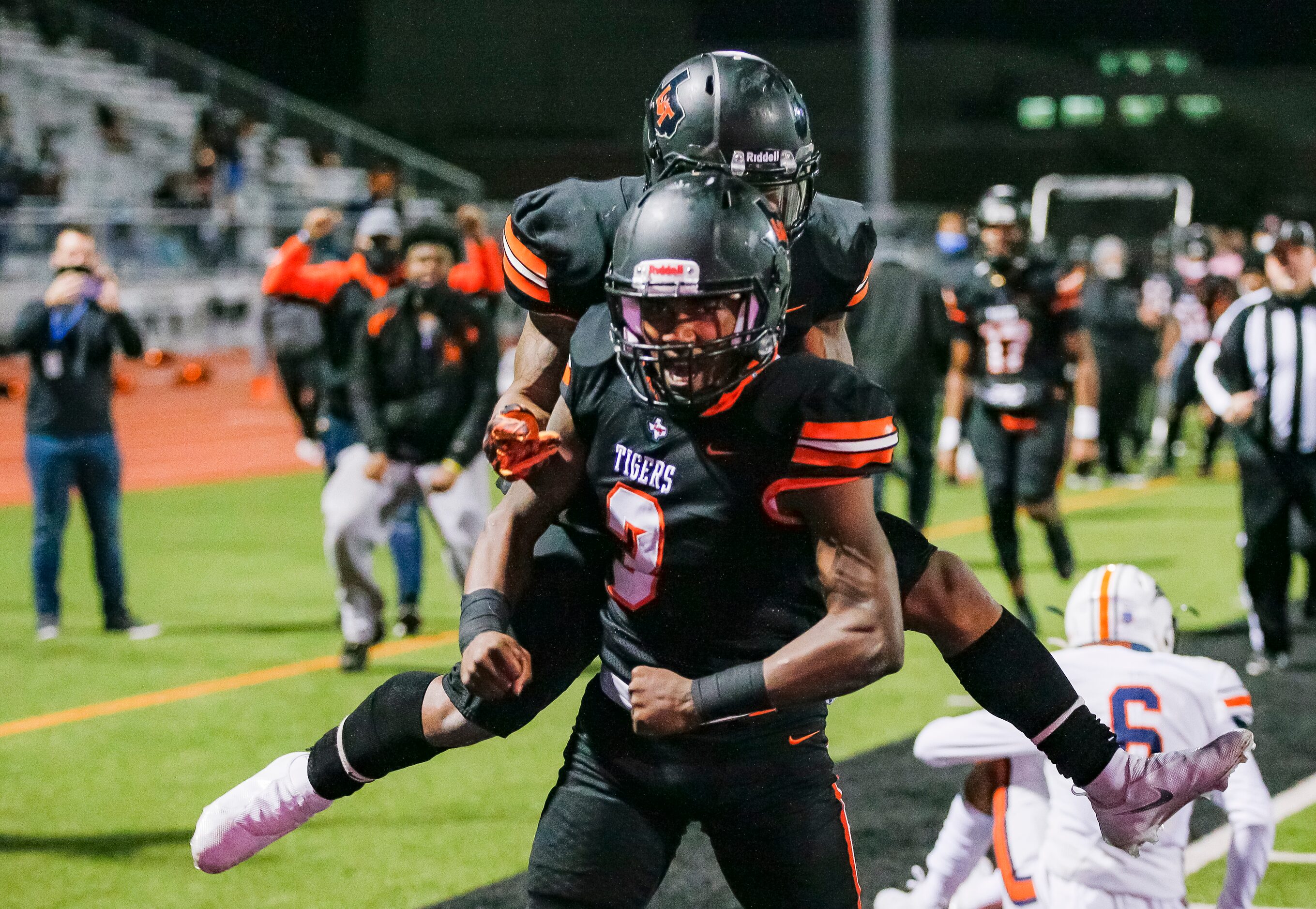 Lancaster junior quarterback Glenn Rice Jr. (3) is congratulated by senior running back DQ...