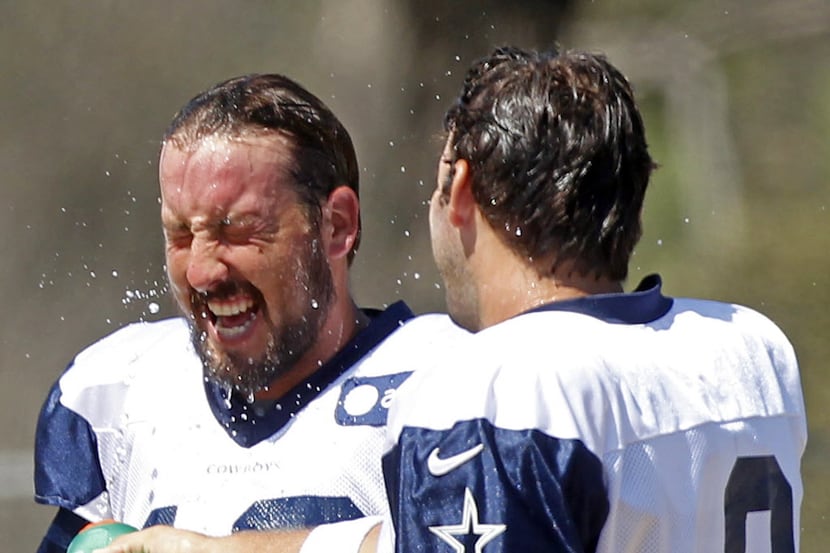 Dallas Cowboys quarterback Kyle Orton (18) gets cooled off with water by  quarterback Tony...