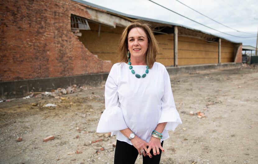Joanne Craven, general manager of Meletio Lighting, behind the building along Harry Hines...