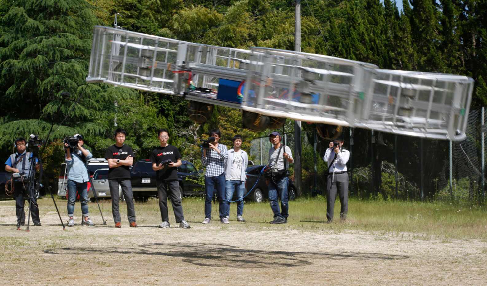 Tsubasa Nakamura, project leader of Cartivator, third from left, watches the flight of the...
