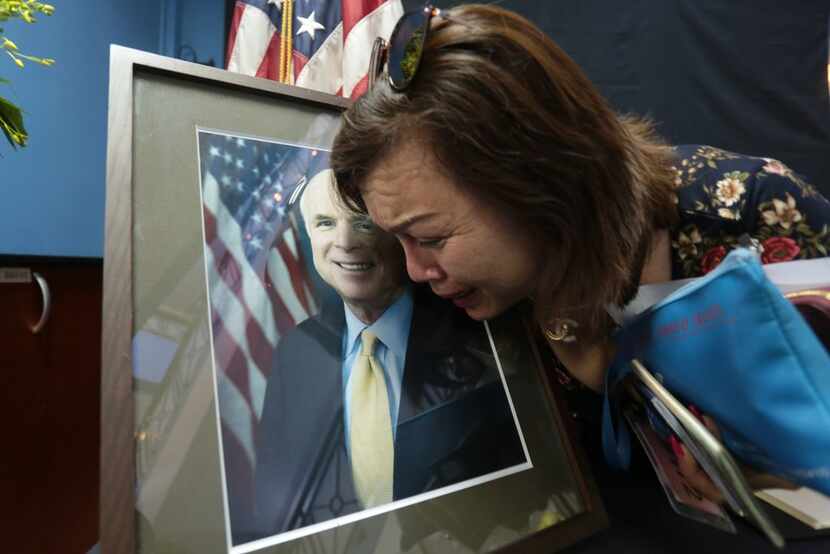 Mai Tran, an American of Vietnamese descent, grieves over the portrait of Sen. John McCain...