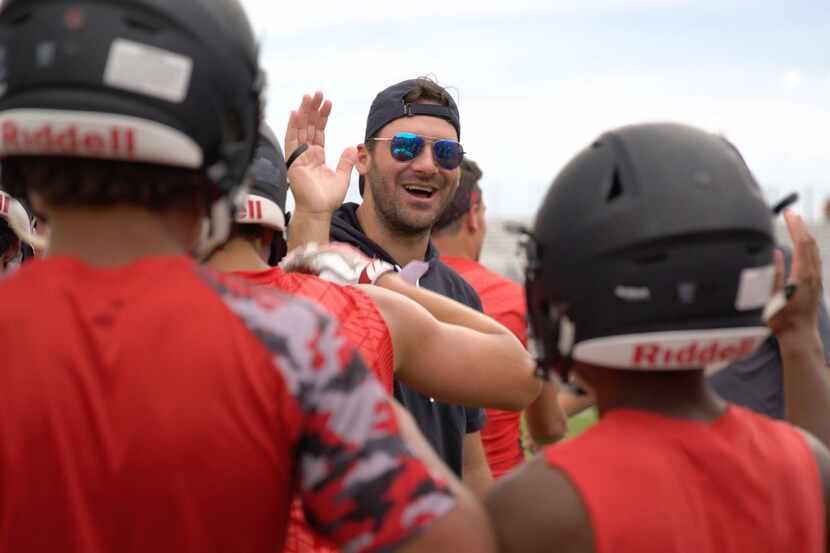 Tony Romo instructs kids on the finer points of football at his annual camp in Burlington,...