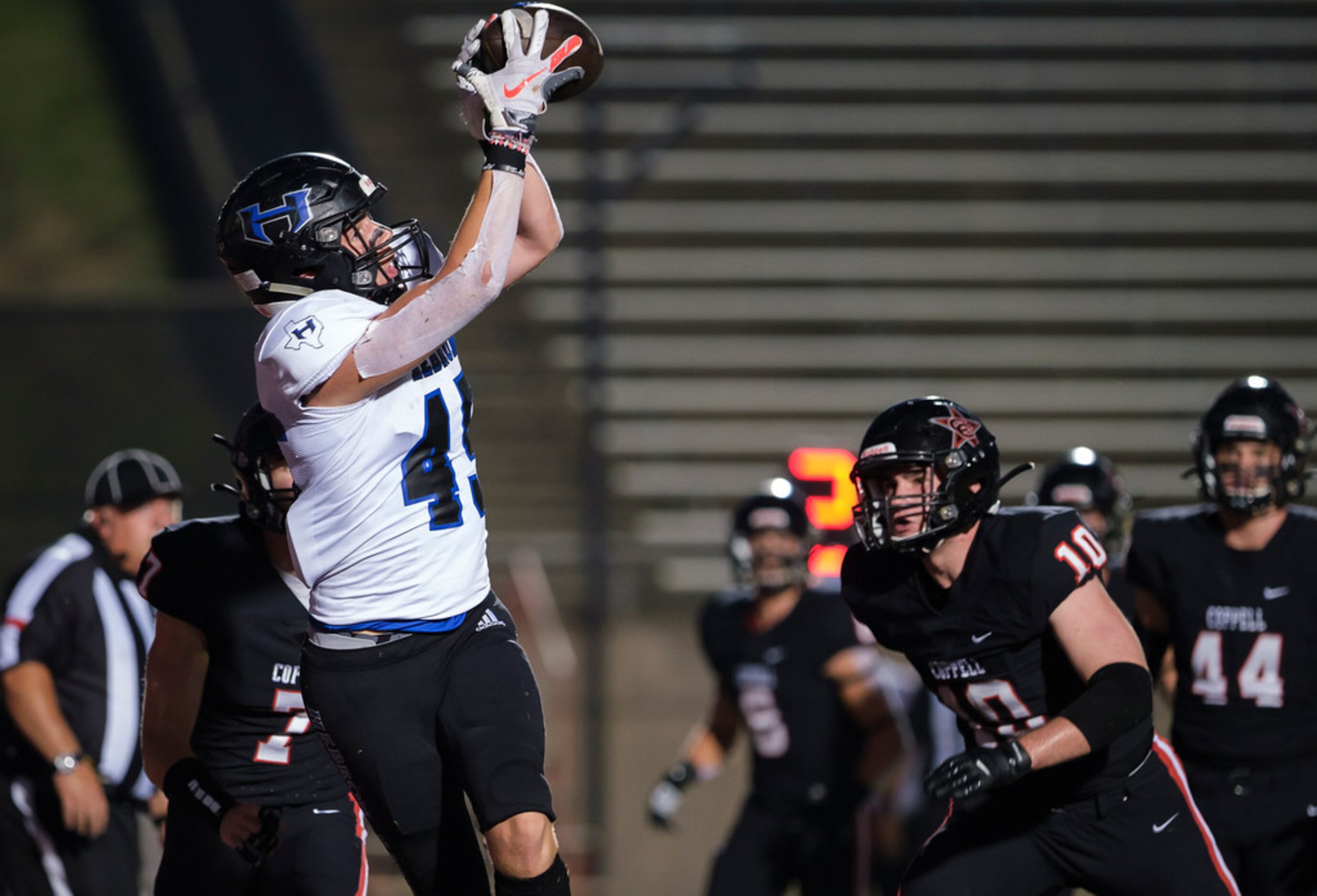 Hebron tight end  Ben Rutherford (45) catches a touchdown pass as Coppell defensive back...