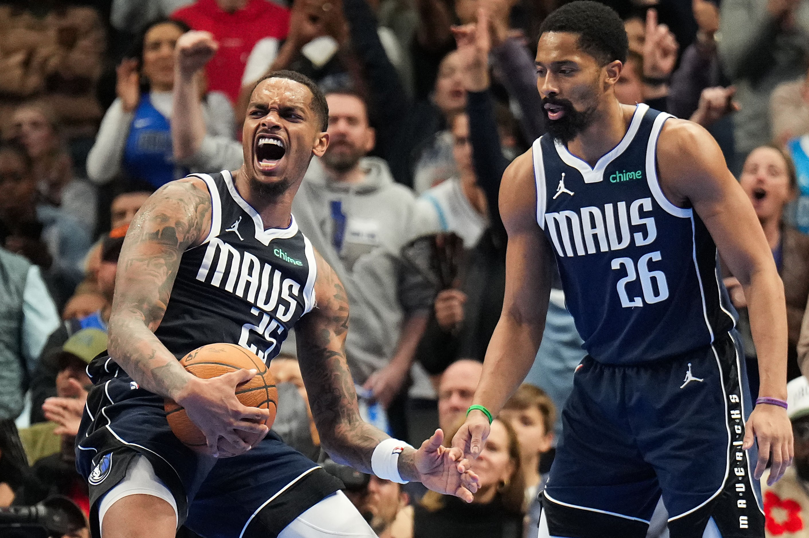 Dallas Mavericks forward P.J. Washington (25) reacts with guard Spencer Dinwiddie (26) ...