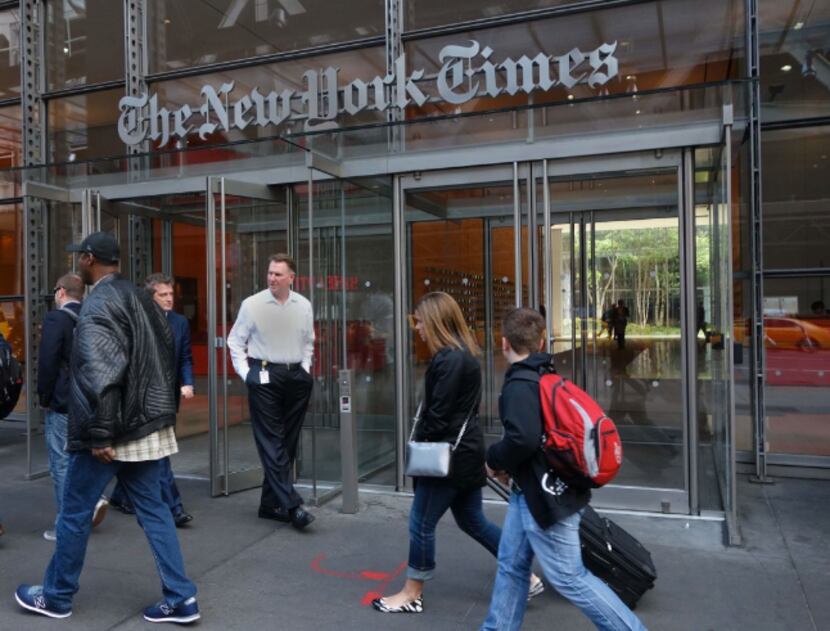 People walking past the west entrance of the New York Times building at 620 Eighth Ave. in...