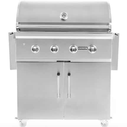 Silver grill with large hood, knobs in front and large cabinets underneath