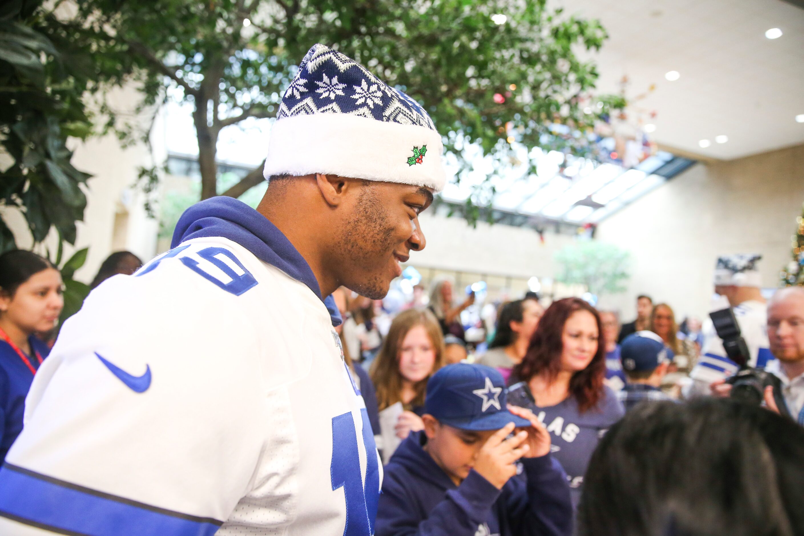 Dallas Cowboys wide receiver Amari Cooper (19) prepares to sing memorabilia for fans during...