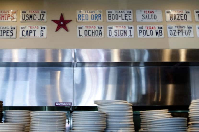 Texas novelty license plates line the wall above the kitchen at a former Hoffbrau Steaks in...