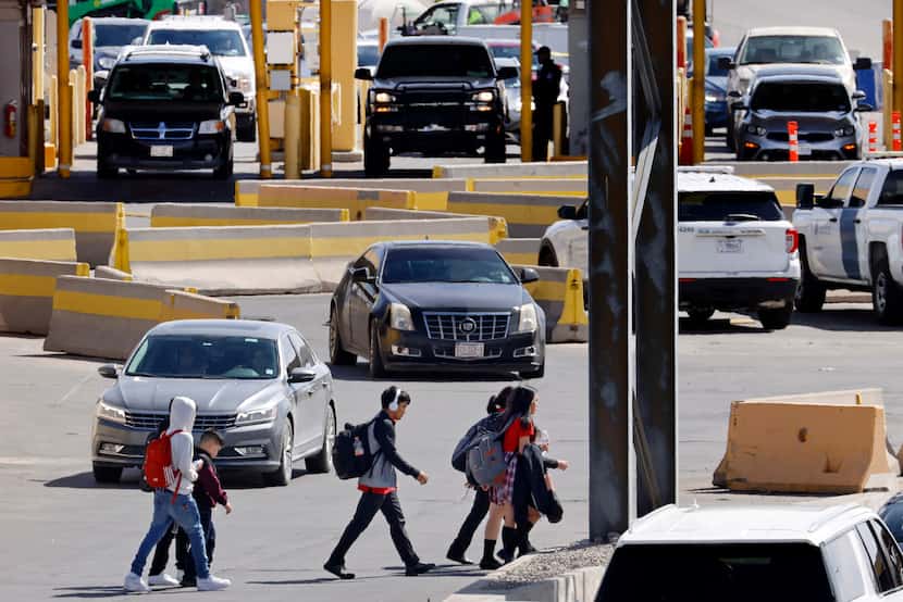 Following classes, schoolchildren in El Paso, Texas cut through traffic arriving from Mexico...