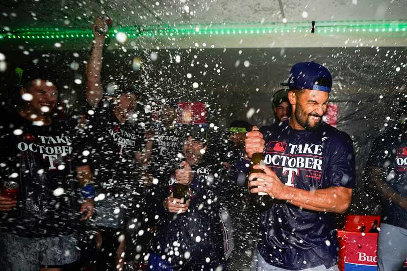 Texas Rangers second baseman Marcus Semien celebrates clinching a playoff spot in the...