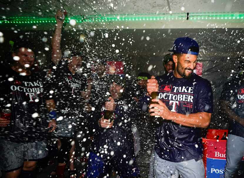 Texas Rangers second baseman Marcus Semien celebrates clinching a playoff spot in the...